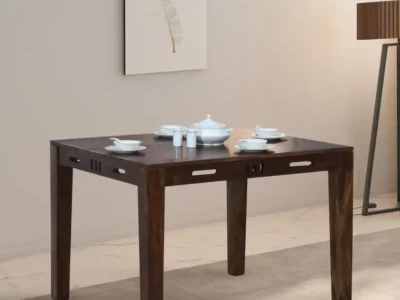 Family dining table with broad wooden base and cushioned seating