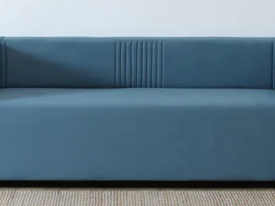 Three seater sofa with side arms and supportive backrest