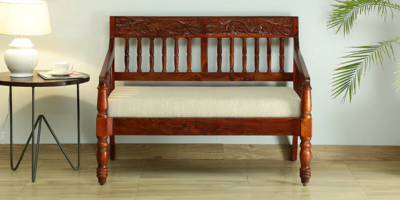 Compact 2 seater sofa with velvet upholstery and wide armrests