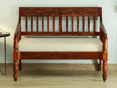 Compact 2 seater sofa with velvet upholstery and wide armrests