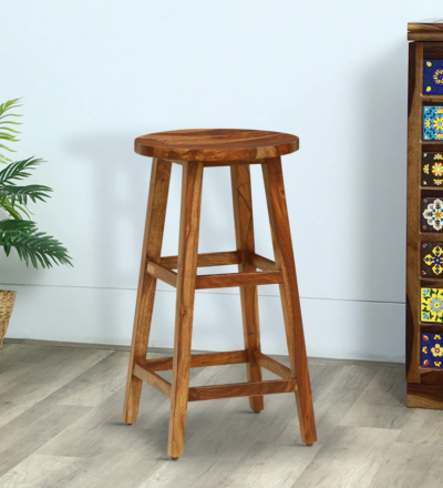 Ember Sheesham wood bar stools by Sarve Furniture – set of 2 Ember bar stool pair with handcrafted wooden finish Solid Sheesham wood Ember stools with natural polish Side view of Ember bar stools showing footrest and frame Ember Sheesham wood stools placed in modern kitchen setup Close-up of Ember wooden seat and legs – elegant design Ember bar stool set with smooth curves and ergonomic support Pair of Ember stools in rustic Sheesham wood texture Ember bar stools designed by Sarve Furniture for modern homes Handcrafted Ember Sheesham stools – perfect for home bars