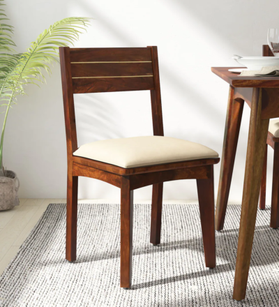 Set of two Lair Sheesham wood cushioned dining chairs with intricate brass inlay by Sarve Furniture, combining elegance and comfort for modern dining spaces.