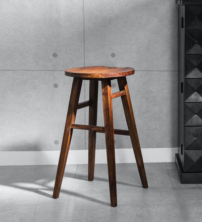 Vantage Sheesham wood tall bar stool by Sarve Furniture Close-up of handcrafted Vantage tall bar stool in Sheesham wood Vantage tall bar stool with natural wood finish and ergonomic design Sheesham wood Vantage tall bar stool for modern kitchens Sleek Vantage Sheesham wood bar stool in tall design Solid Sheesham wood tall bar stool by Sarve Furniture Side view of Vantage Sheesham tall bar stool with backrest Elegant Vantage tall bar stool with footrest and wooden texture Handcrafted Vantage Sheesham wood bar stool for home bar Full view of Vantage Sheesham wood tall bar stool with smooth finish