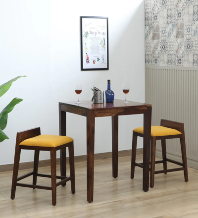 Radiance Sheesham wood bar table set with 2 stools – Sarve Furniture Full view of Radiance bar table and stool set in natural wood finish Radiance Sheesham bar table with matching stools – front angle Side profile of Radiance bar set – rustic Sheesham wood texture Close-up of Radiance wooden tabletop and stool seat detail Compact Radiance bar table set ideal for small spaces Radiance bar set in solid Sheesham wood with handcrafted details Radiance Sheesham bar table set in modern home setup Sturdy wooden bar table and stools – Radiance Sheesham design Radiance bar set by Sarve Furniture – natural polish and elegant build