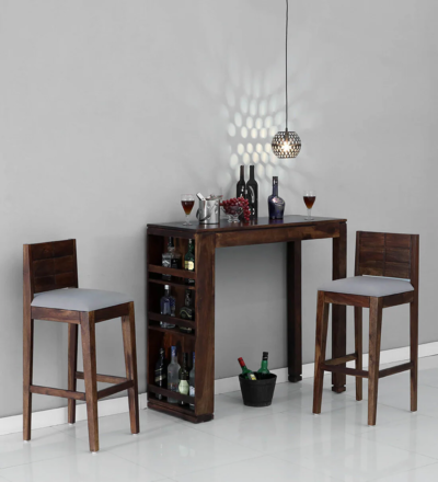 Monarch bar table set with 2 grey cushioned stools – Sarve Furniture Monarch bar table and stools in grey and wooden finish – front view Close-up of grey cushioned bar stools from Monarch set Monarch bar table with sleek top and soft padded stools
